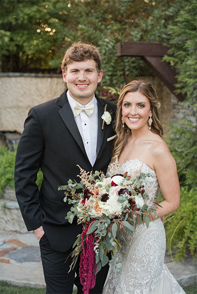 A bride and groom posing at their wedding.