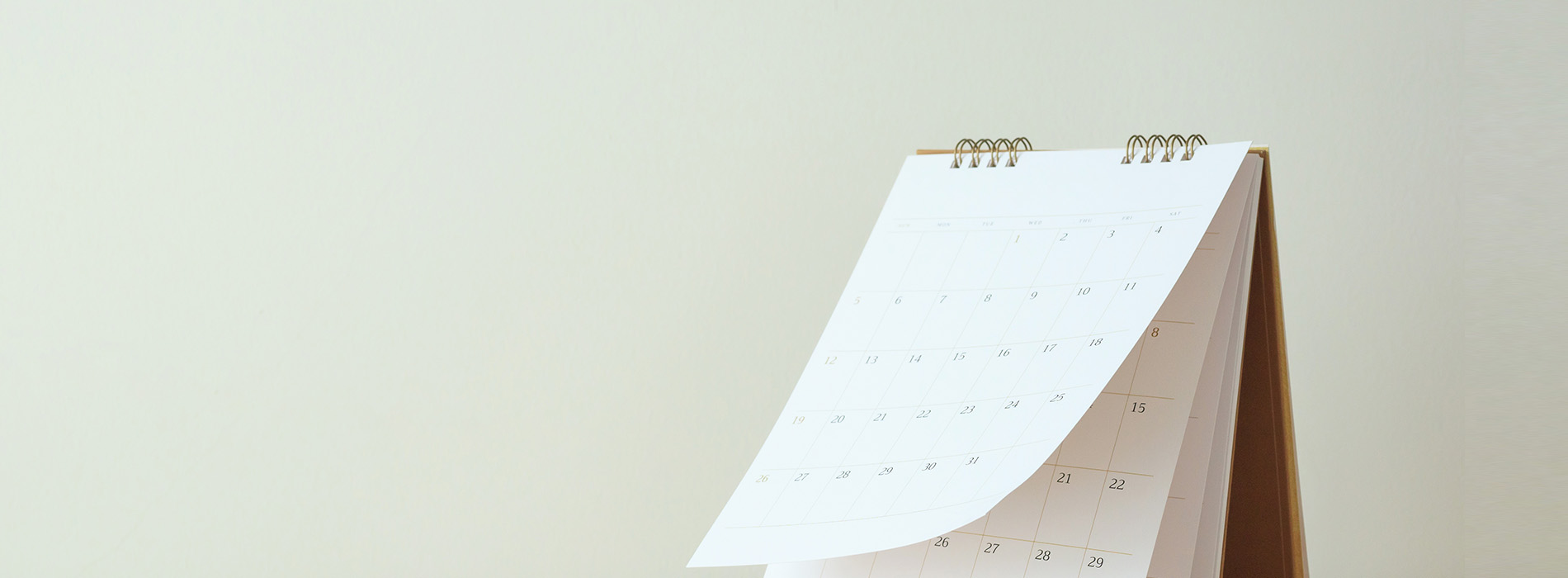 The image shows a calendar with the days of the week at the top, displayed on a surface against a plain background.